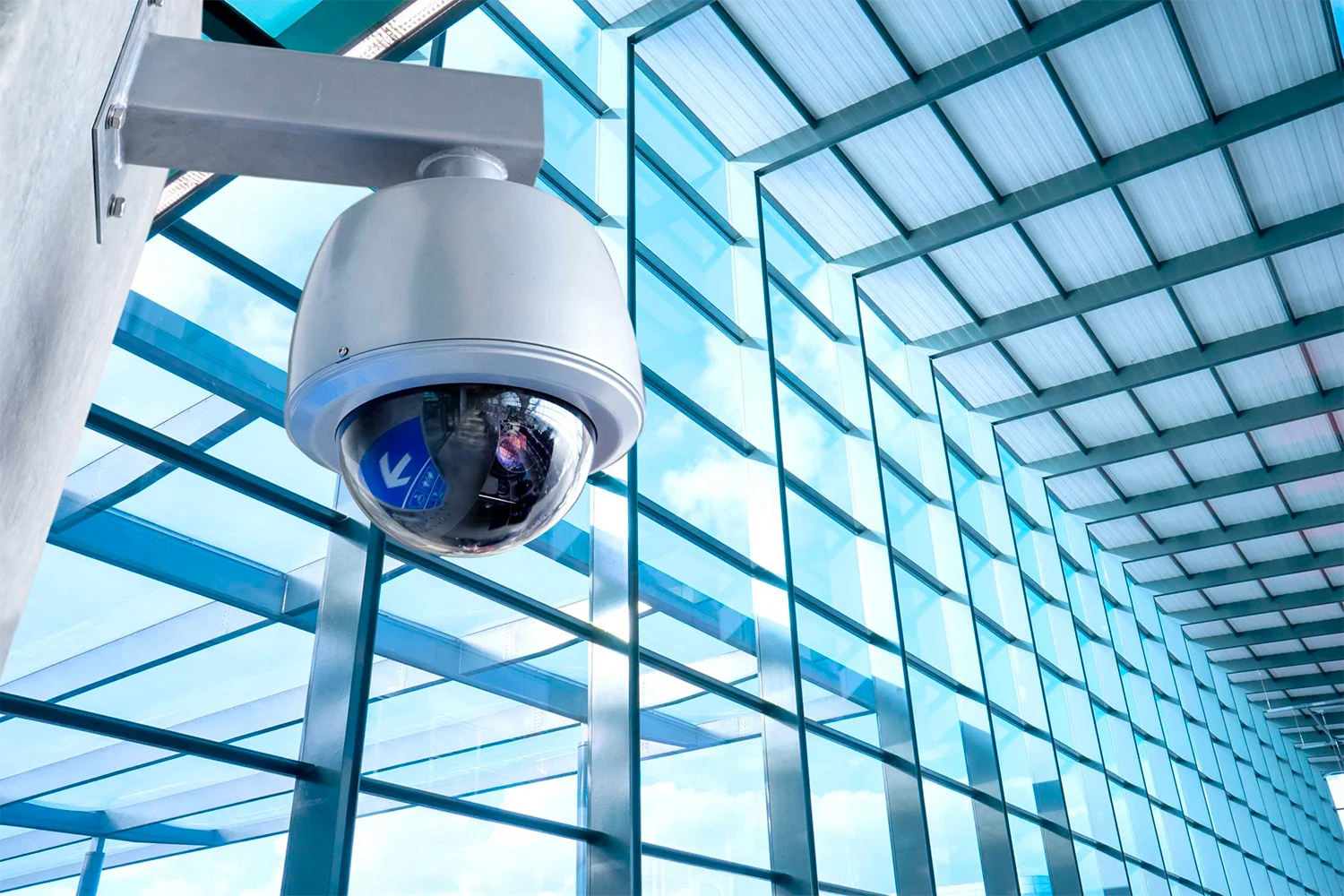 Commercial security camera installed in a large office window